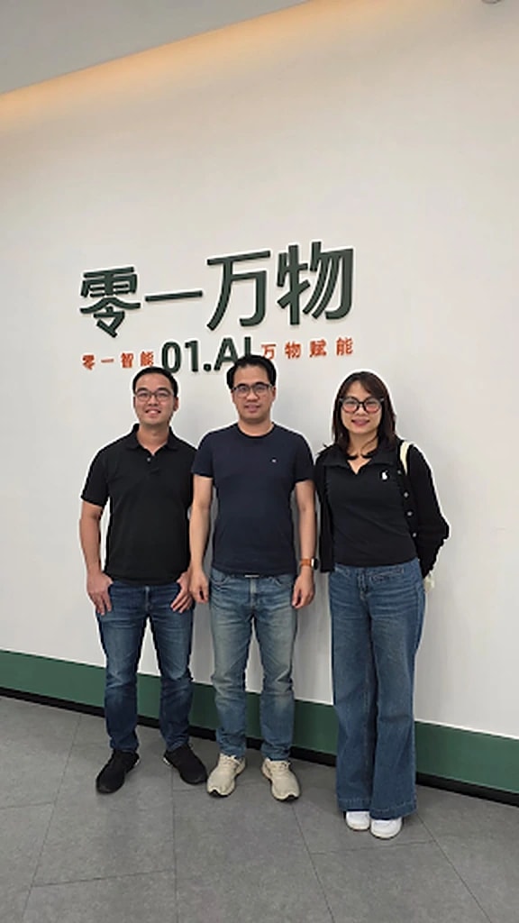 GenAI Fund team at the 01.AI office in front of the company sign
